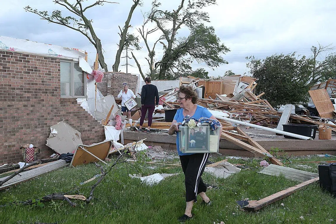 Volunteers clean up after a tornado touched down in Nevada, Iowa on May 21.