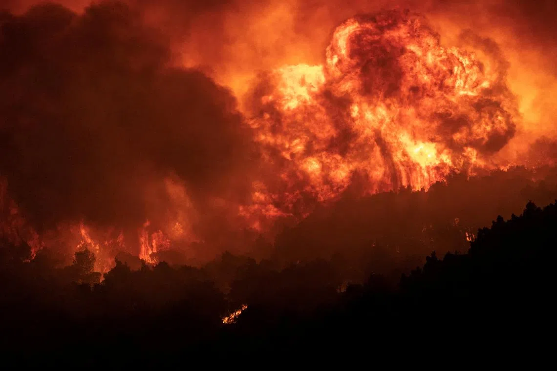 Flames rising as wildfires burn on Mount Parnitha, in Athens, Greece, Aug 24,