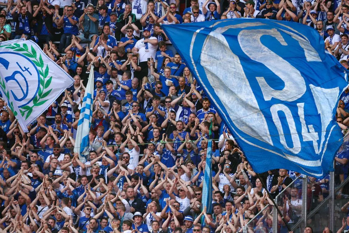 Supporters of Schalke 04 cheer on their team during a match. Former World Cup-winning Germany striker Jurgen Klinsmann believes that German fans stick with their team even if they get relegated.