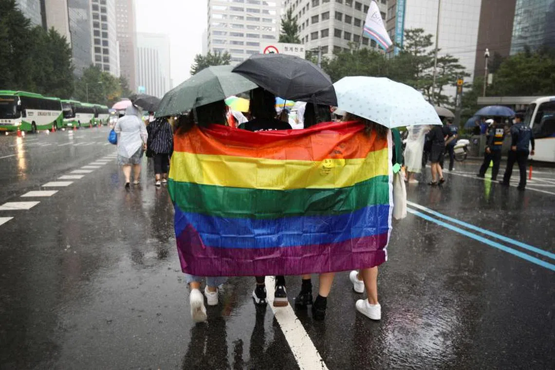 FILE PHOTO: Participants wave a rainbow flag as they march on a street during the Korea Queer Culture Festival 2022 in central Seoul, South Korea, July 16, 2022.  REUTERS/ Heo Ran/File Photo