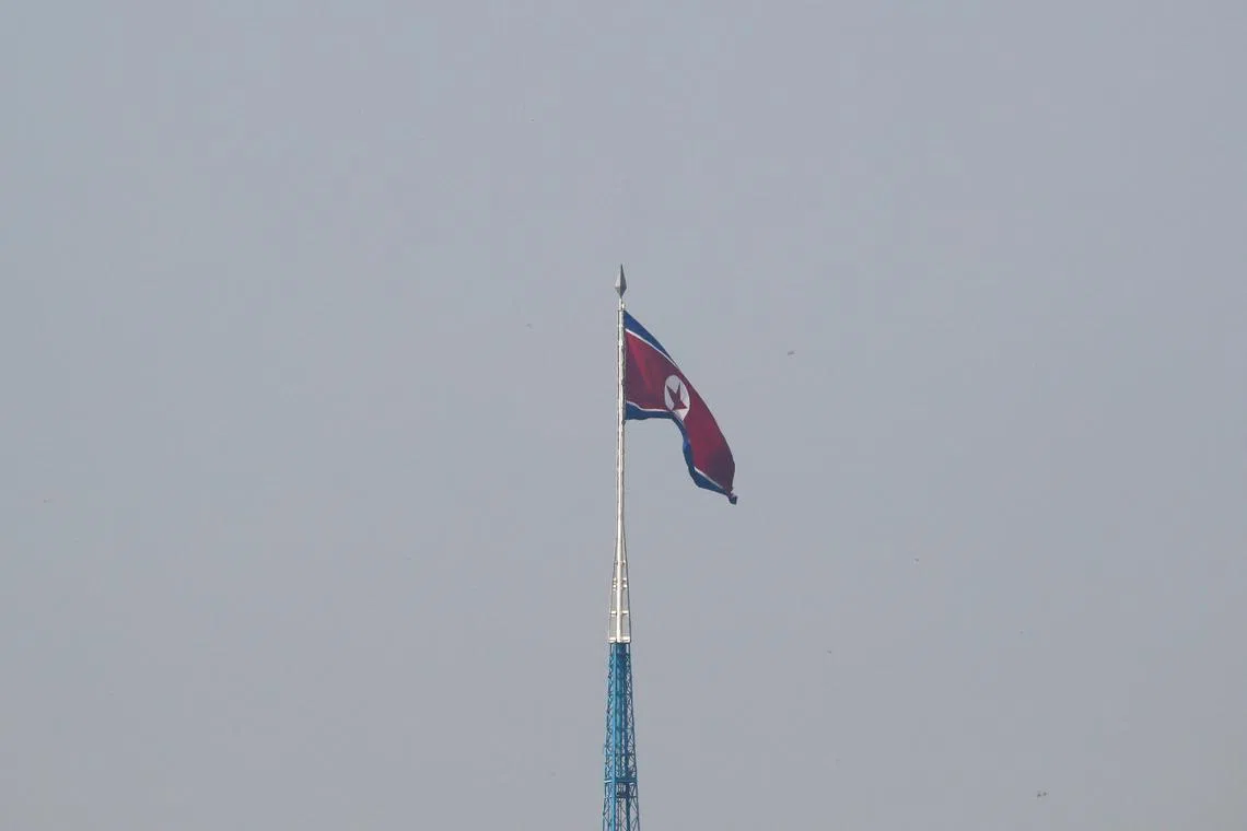 FILE PHOTO: A North Korean flag flutters on top of the 160-metre tall tower at North Korea's propaganda village of Gijungdong, in this picture taken from Tae Sung freedom village near the Military Demarcation Line (MDL), inside the demilitarised zone separating the two Koreas, in Paju, South Korea, September 30, 2019. REUTERS/Kim Hong-Ji/File photo