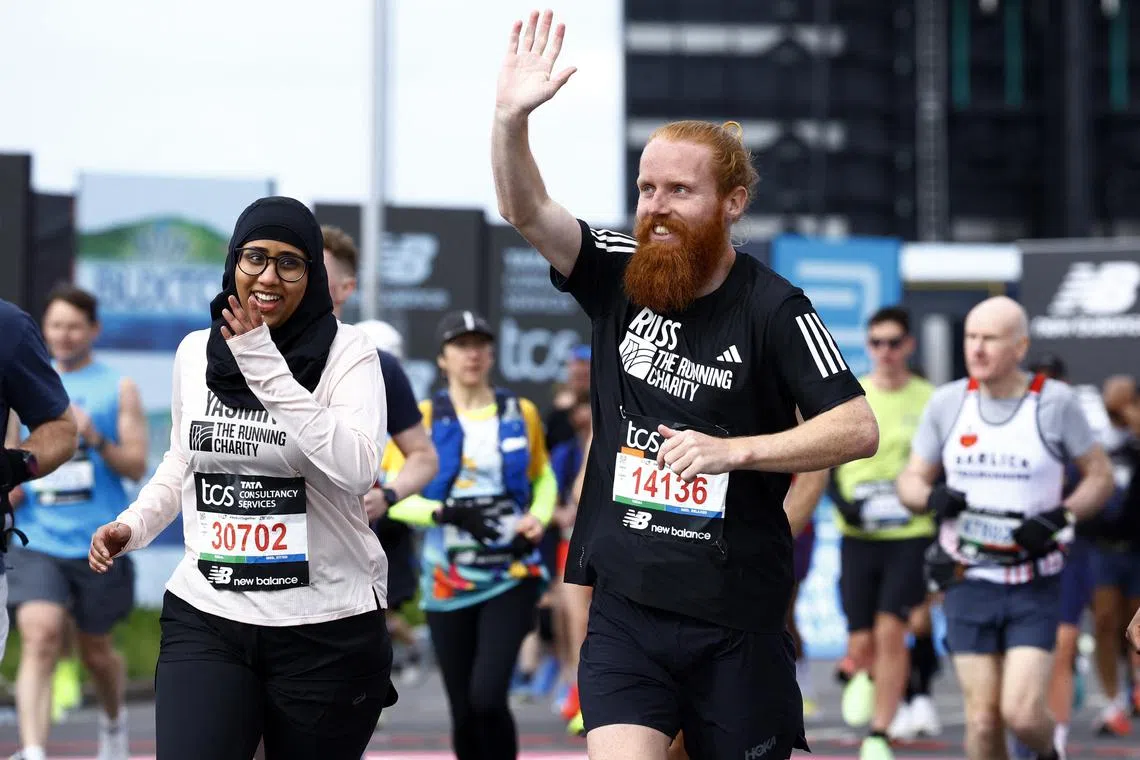 FILE PHOTO: Athletics - London Marathon - London, Britain - April 21, 2024  Britain's Russ Cook and Yasmin Mahamud in action during the marathon REUTERS/John Sibley/File Photo