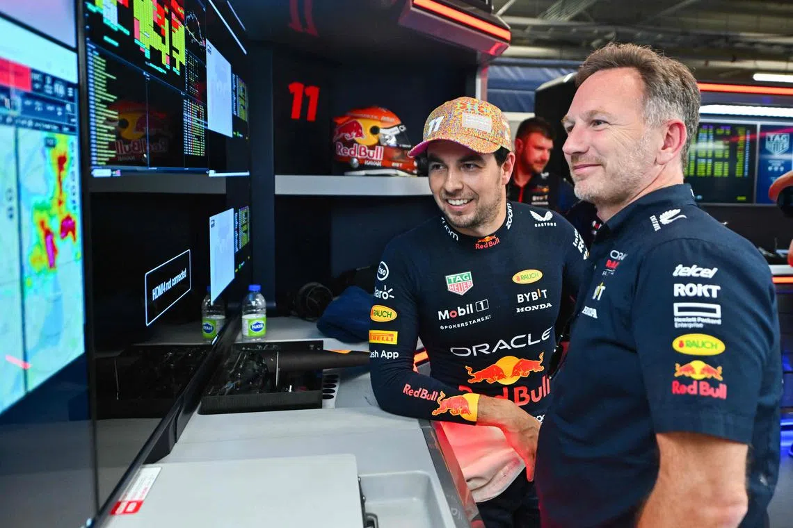 Red Bull's Sergio Perez and team boss Christian Horner in the garage during practice ahead of the Canadian Grand Prix.