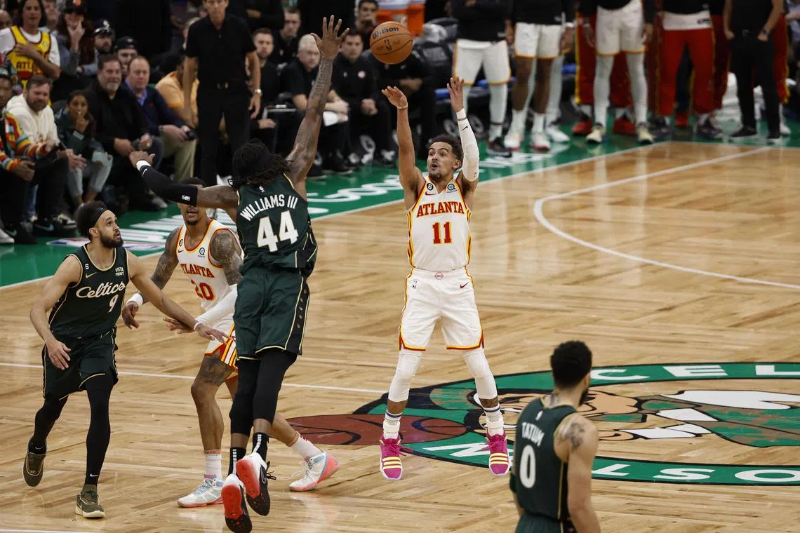 Atlanta Hawks guard Trae Young (11) shooting a  three-point shot over Boston Celtics centre Robert Williams III during the fourth quarter of game five of the NBA play-offs at TD Garden. 