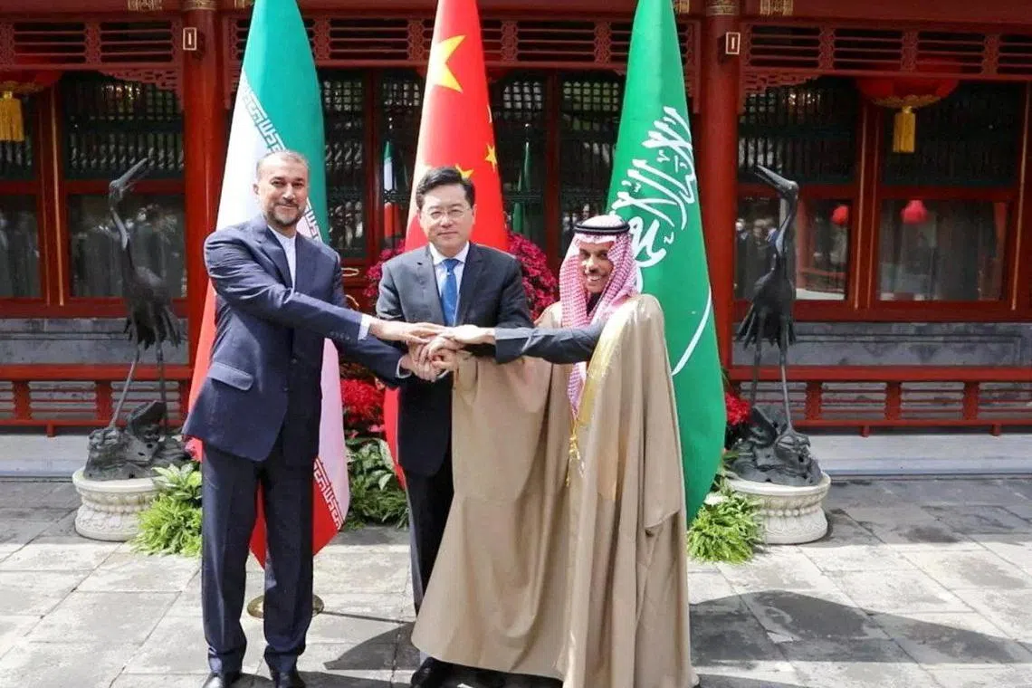 Iranian Foreign Minister Hossein Amir-Abdollahian (left) and Saudi Arabia's Foreign Minister Prince Faisal bin Farhan Al Saud (rght) with Chinese Foreign Minister Qin Gang in Beijing on April 6.