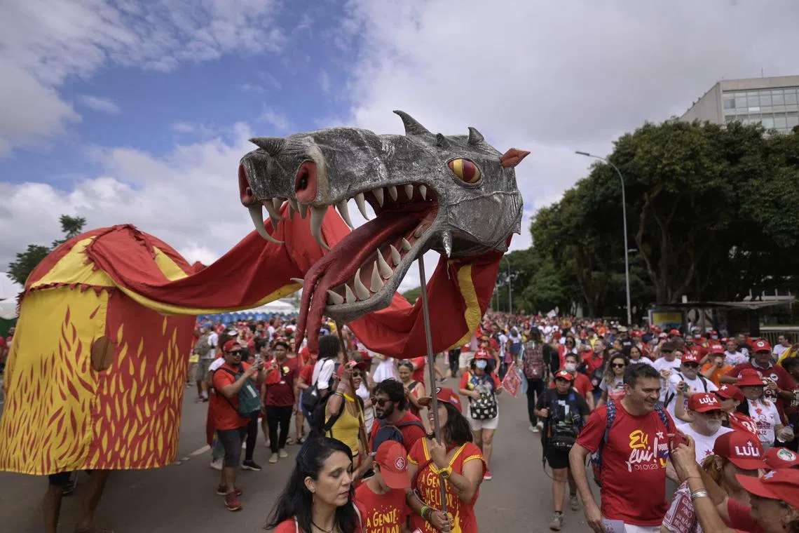 Supporters of President-elect Luiz Inacio Lula da Silva arrive at the Esplanada dos Ministerios to attend his inauguration ceremony in Brasilia on January 1, 2023. - Lula da Silva, a 77-year-old leftist who already served as president of Brazil from 2003 to 2010, takes office for the third time with a grand inauguration in Brasilia. (Photo by DOUGLAS MAGNO / AFP)