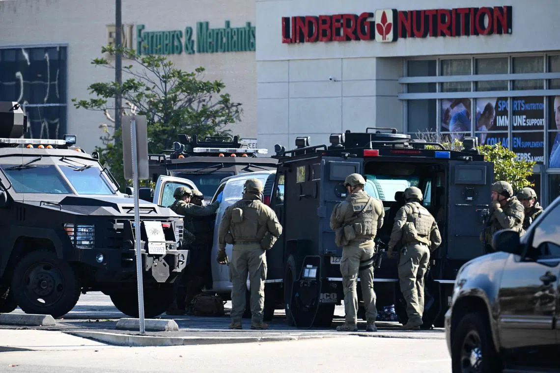 Law enforcement personnel open the door of a van in Torrance, California, where the alleged suspect in a mass shooting is believed to be holed up. PHOTO: AFP