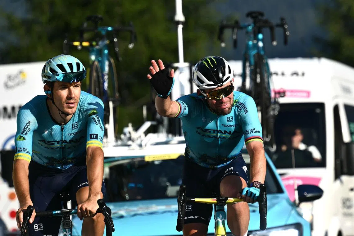 Astana Qazaqstan Team's British rider Mark Cavendish (R) waves his hand as he crosses the finish line of the 20th stage of the 111th edition of the Tour de France cycling race, 132,8 km between Nice and Col de la Couillole, southeastern France, on July 20, 2024. (Photo by Marco BERTORELLO / AFP)