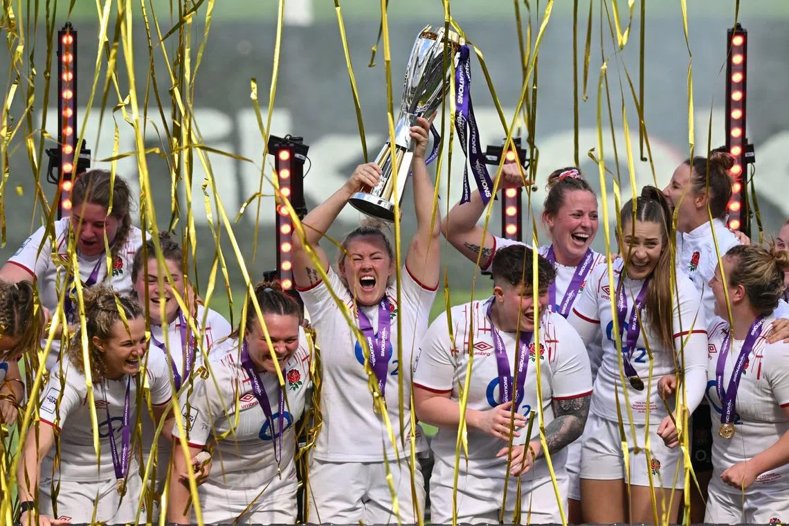 England celebrating with the trophy after winning the Women's Six Nations Grand Slam at the end of the Six Nations international women's rugby union match between England and France at Twickenham in south-west London on Saturday. England won 38-33.