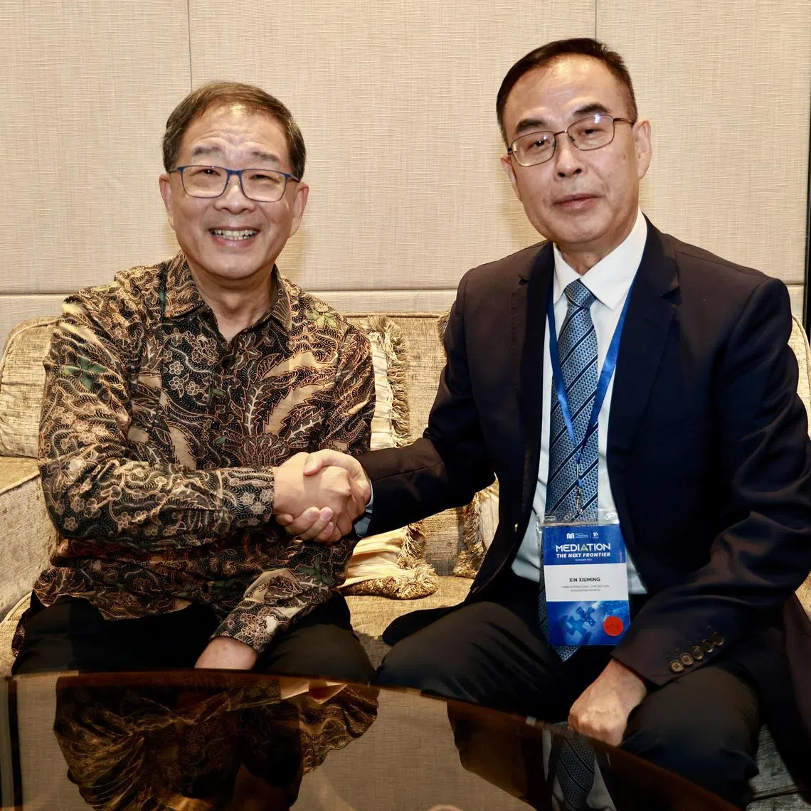 SIMC chairman George Lim (left) and China International Contractors Association vice-chairman Xin Xiuming at Shangri-La Hotel on Aug 28.