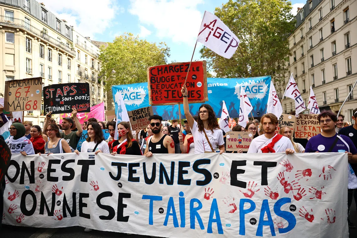 Protesters hold a banner reading \"We are young, and we won't stay silent\" during a demonstration by French high school and university students in Paris as part of a nationwide protest movement led by students, supported by teachers, school parents and labour unions, demanding better school conditions and concrete measures, France, October 13, 2026.   REUTERS/Sarah Meyssonnier
