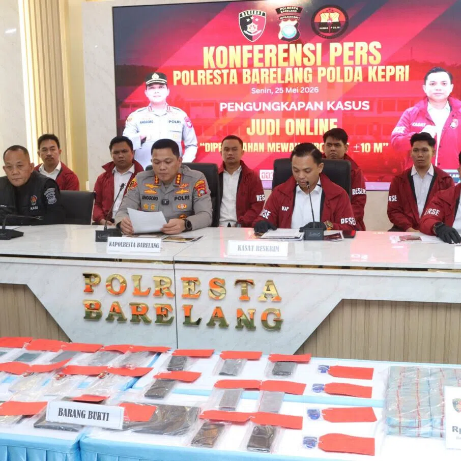 Batam, Rempang and Galang Police chief Anggoro Wicaksono reads a statement on May 25, 2026, during a press conference in Batam on a raid that dismantled the Indonesian branch of an multinational gambling network in the Riau Islands city.

