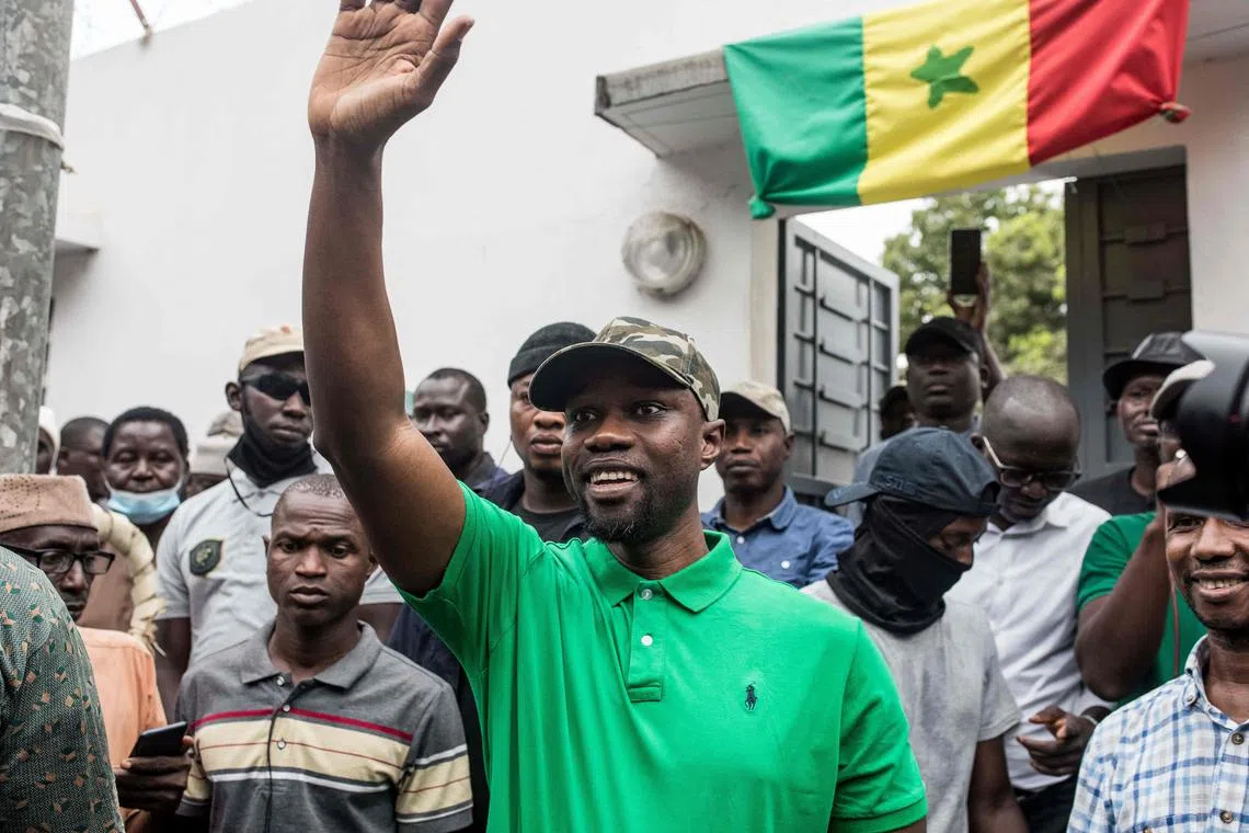 Opposition leader Ousmane Sonko waves to his supporters during a meeting in Ziguinchor on May 24. He was sentenced to two years' jail on Thursday for "corrupting youth".