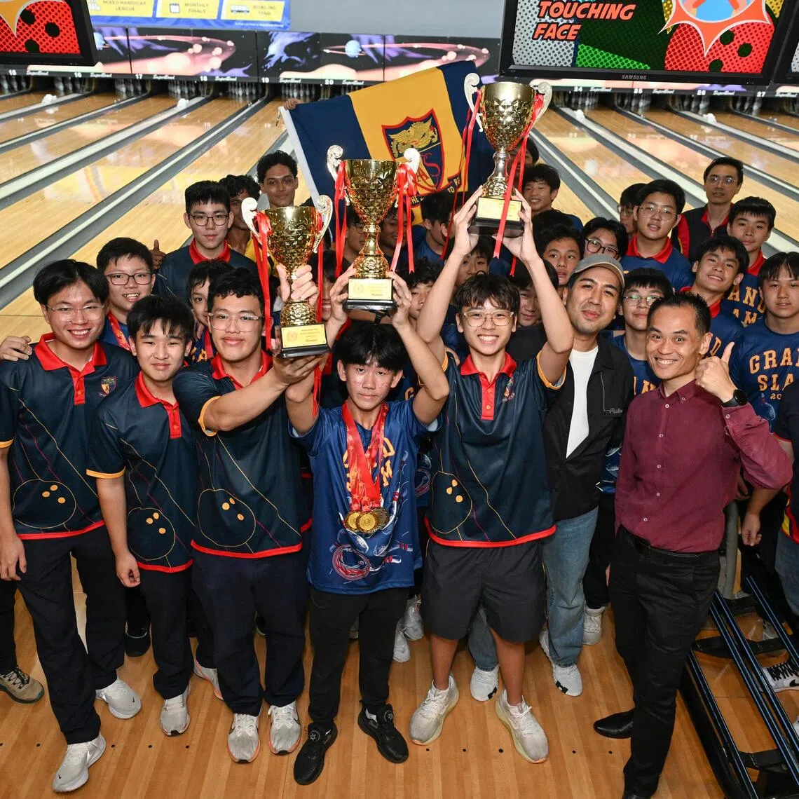 Anglo-Chinese School (Independent)’s A, B and C Division teams posing with their trophies after completing a grand slam of National School Games bowling titles on July 30.  C Division captain Vallen Shin (centre, with three medals) and teacher in-charge Benjamin Wong (with cap) both hailed the team effort.