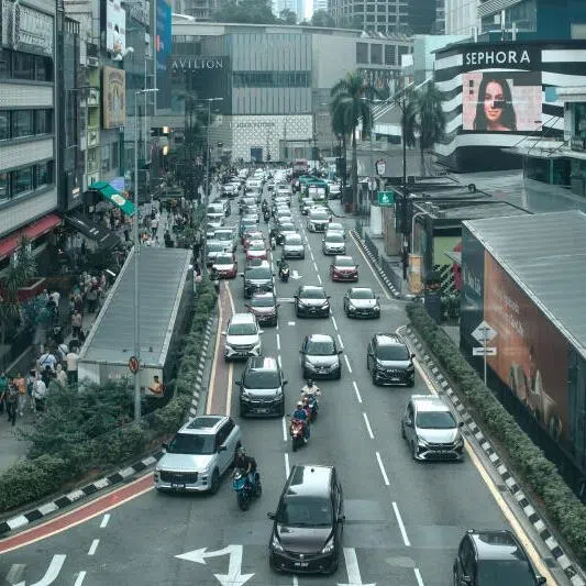 Vehicles on a road in the Bukit Bintang business area in Kuala Lumpur, Malaysia.