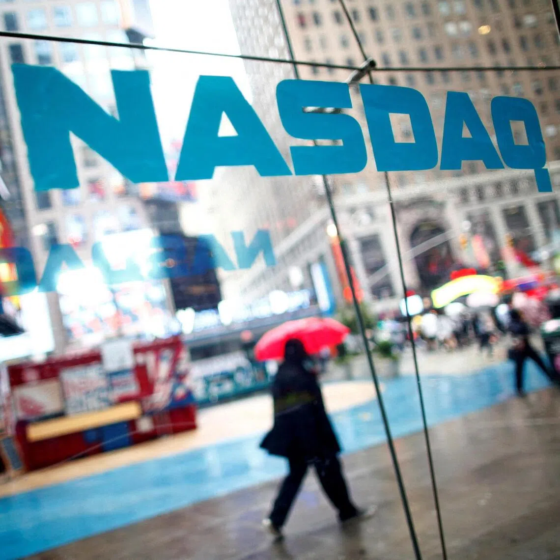 FILE PHOTO: Pedestrians walk past the NASDAQ MarketSite in New York's Times Square in this June 4, 2012 file photo. REUTERS/Eric Thayer/File Photo