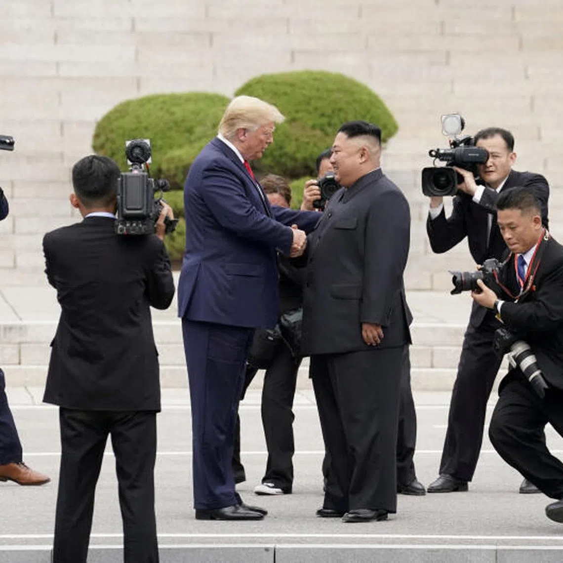 FILE PHOTO: U.S. President Donald Trump meets with North Korean leader Kim Jong Un at the demilitarized zone separating the two Koreas, in Panmunjom, South Korea, June 30, 2019. REUTERS/Kevin Lamarque/File Photo SEARCH "GLOBAL POY" FOR THIS STORY. SEARCH "REUTERS POY" FOR ALL BEST OF 2019 PACKAGES. TPX IMAGES OF THE DAY./File Photo