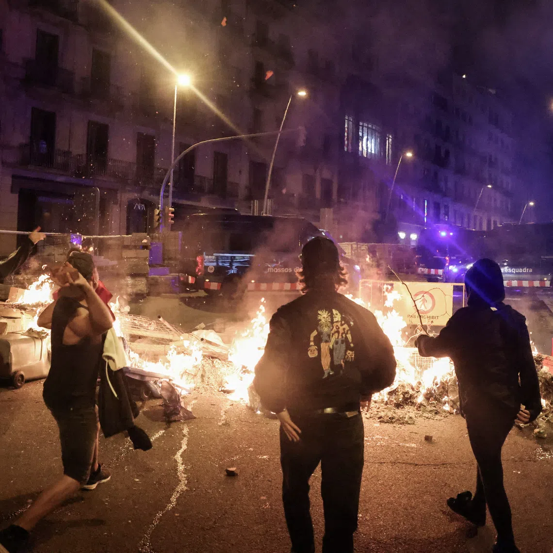 Demonstrators throw bricks toward police vehicles during a protest calling for political action to address Spain's housing crisis in Barcelona, Spain, October 5, 2026. REUTERS/Nacho Doce