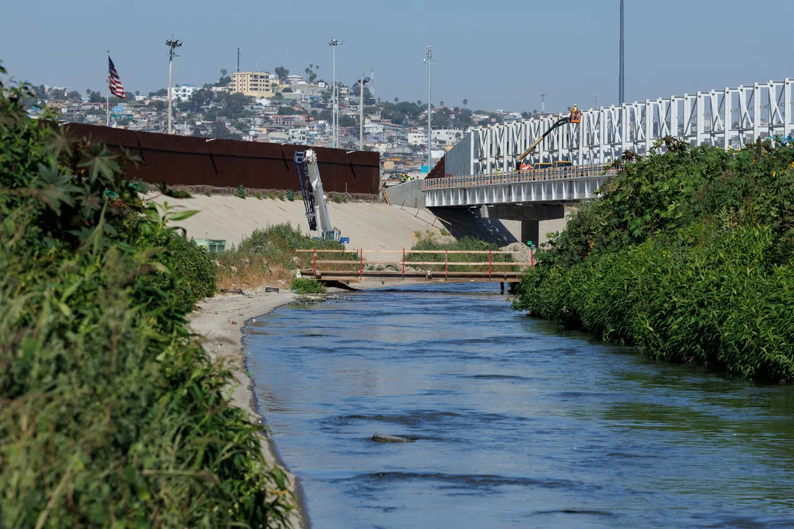 Raw sewage flows along the Tijuana river located between the primary and secondary borders next to Tijuana, Mexico in San Diego, California, U.S., June 27, 2024.  REUTERS/Mike Bake