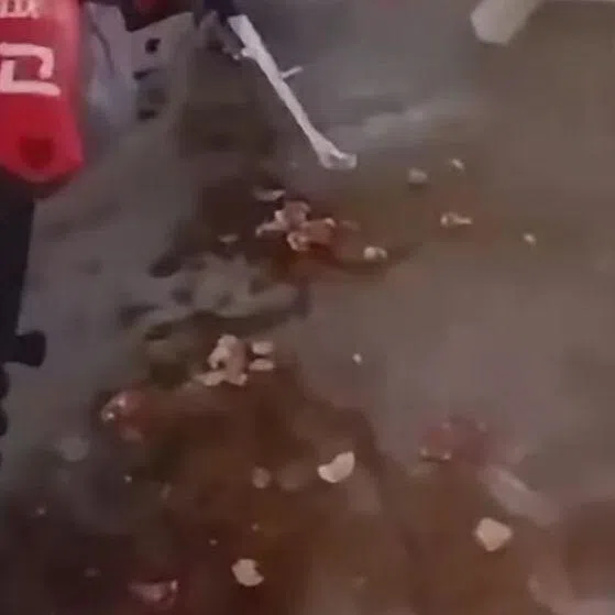 Aftermath of the motorcycle covered with what appears to be raw eggs.