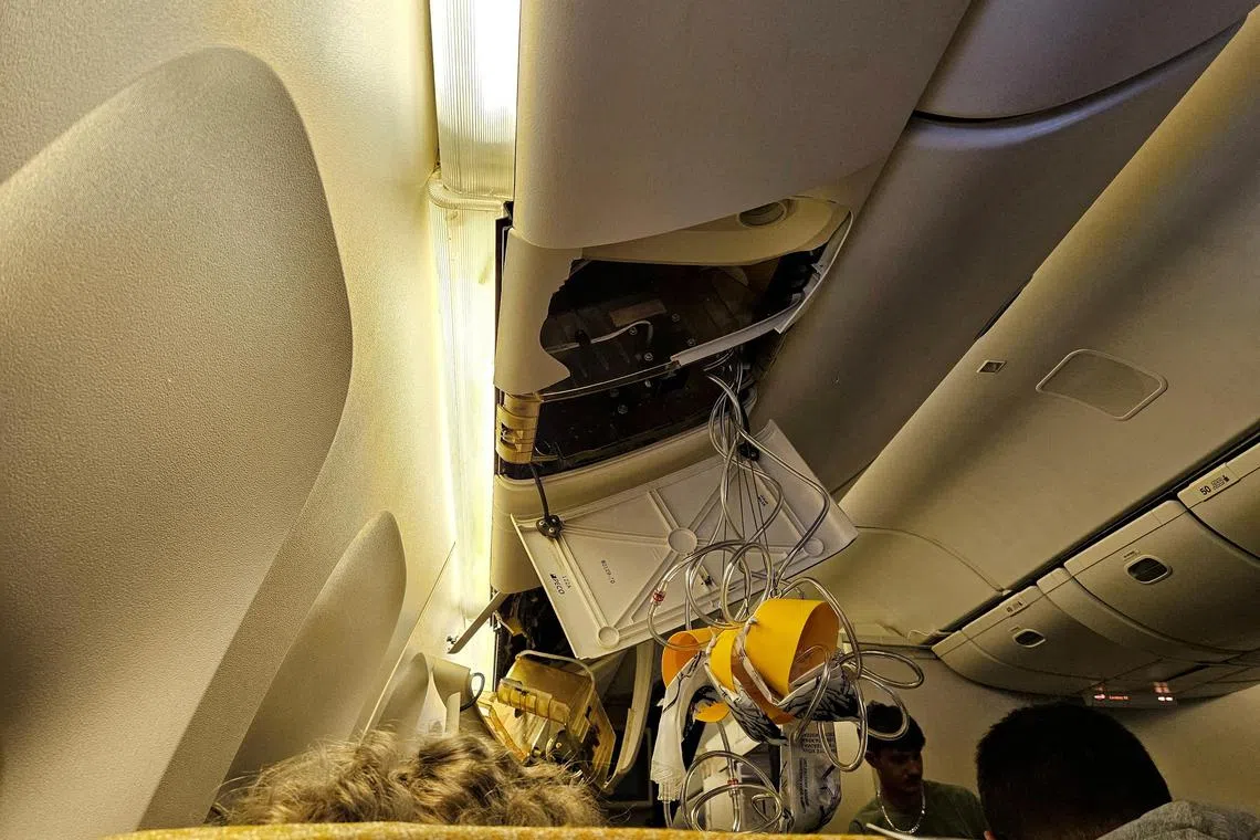Oxygen masks seen onboard Singapore Airlines flight SQ321 after an emergency landing in Bangkok following "sudden extreme turbulence".