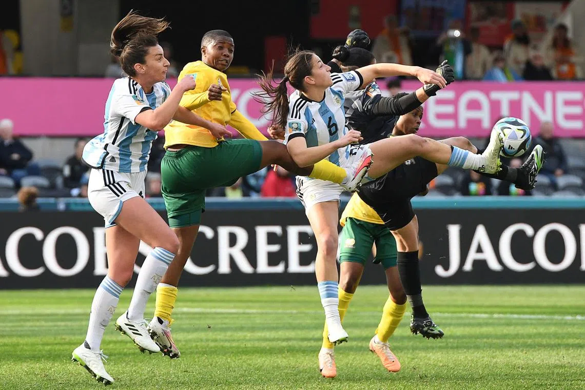 Argentina's defender #13 Sophia Braun (L), South Africa's defender #03 Bongeka Gamede (C) and Argentina's midfielder #06 Aldana Cometti jump for the ball during the Australia and New Zealand 2023 Women's World Cup Group G football match between Argentina and South Africa at Dunedin Stadium in Dunedin on July 28, 2023. (Photo by Sanka Vidanagama / AFP)