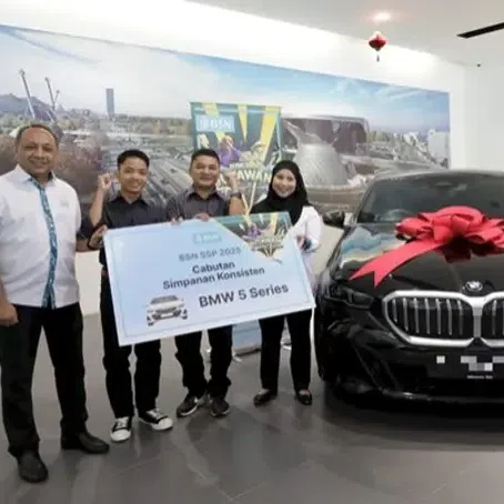 Che Thaqif Dzakwan, 14, is now the owner of a BMW car after winning the Bank Simpanan Nasional Premium Savings Certificate draw.