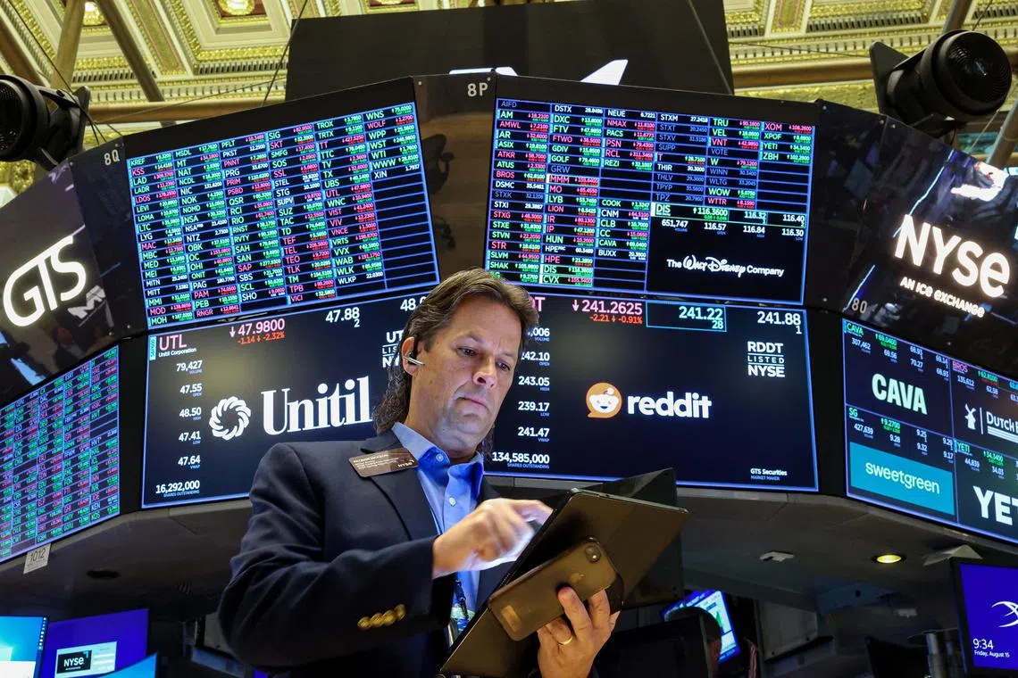 Traders working on the floor of the New York Stock Exchange, in New York City, on Aug 15.