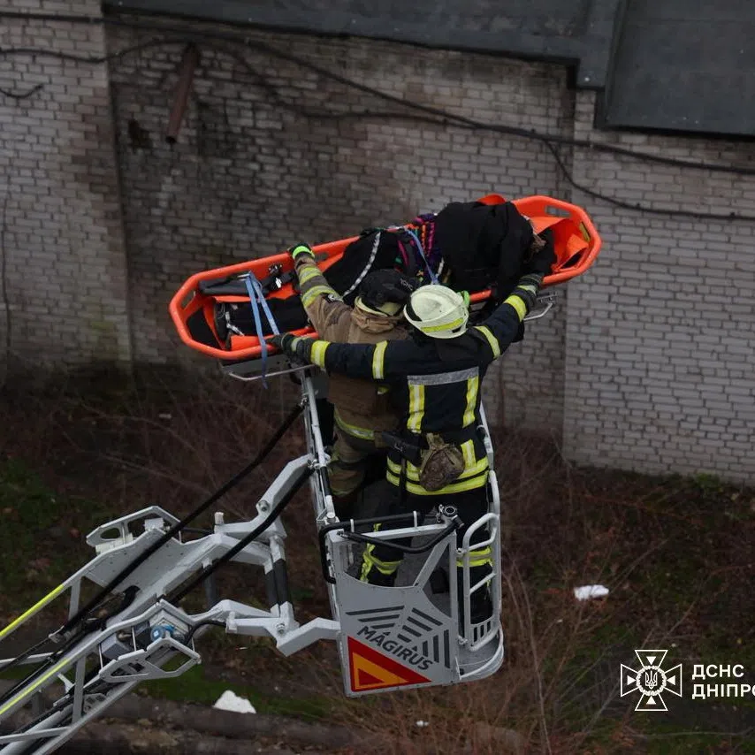 Rescuers evacuate a person from the site of a midday Russian missile strike, amid Russia's attack on Ukraine, in Dnipro, Ukraine December 1, 2025. Press service of the State Emergency Service of Ukraine in Dnipropetrovsk region/Handout via REUTERS