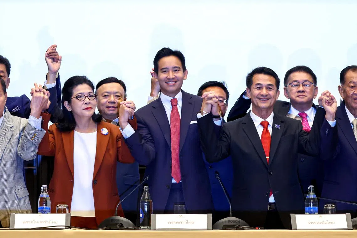 Move Forward Party leader Pita Limjaroenrat holds hands with coalition party leaders following a meeting with coalition partners in Bangkok, Thailand, May 18, 2023. REUTERS/Athit Perawongmetha