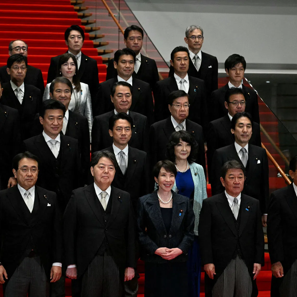 Japan's new Prime Minister Sanae Takaichi (C, first row) poses during a photo session with members of her cabinet at the prime minister's office in Tokyo, Japan October 21, 2025.     PHILIP FONG/Pool via REUTERS   REFILE - CORRECTING LOCATION FROM \"PRIME MINISTER'S OFFICIAL RESIDENCE\" TO \"PRIME MINISTER'S OFFICE\".