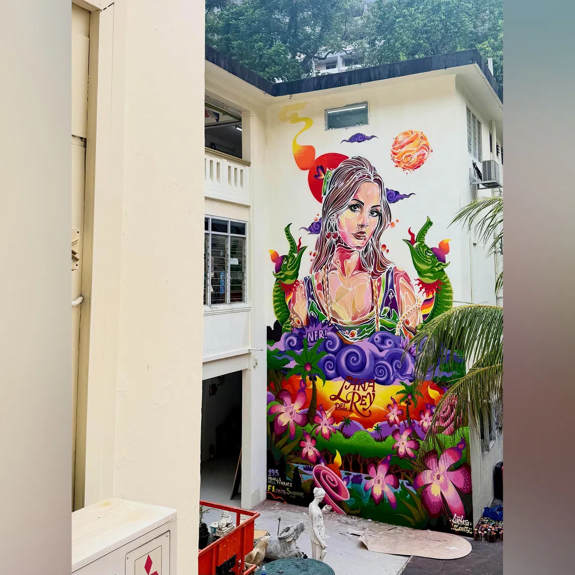 The Lana Del Rey fan event called Honeymoon Pitstop includes a large mural of her by Singaporean graffiti artists Slacsatu and Song.