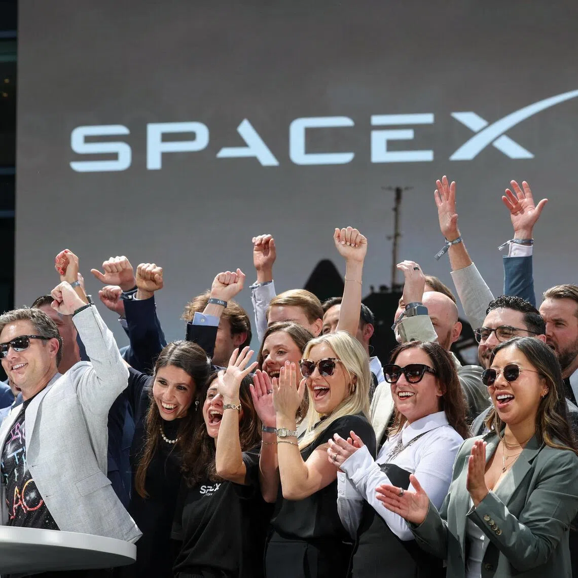 SpaceX executives celebrated at the Nasdaq market site in New York’s Times Square after ringing the opening bell on June 12.