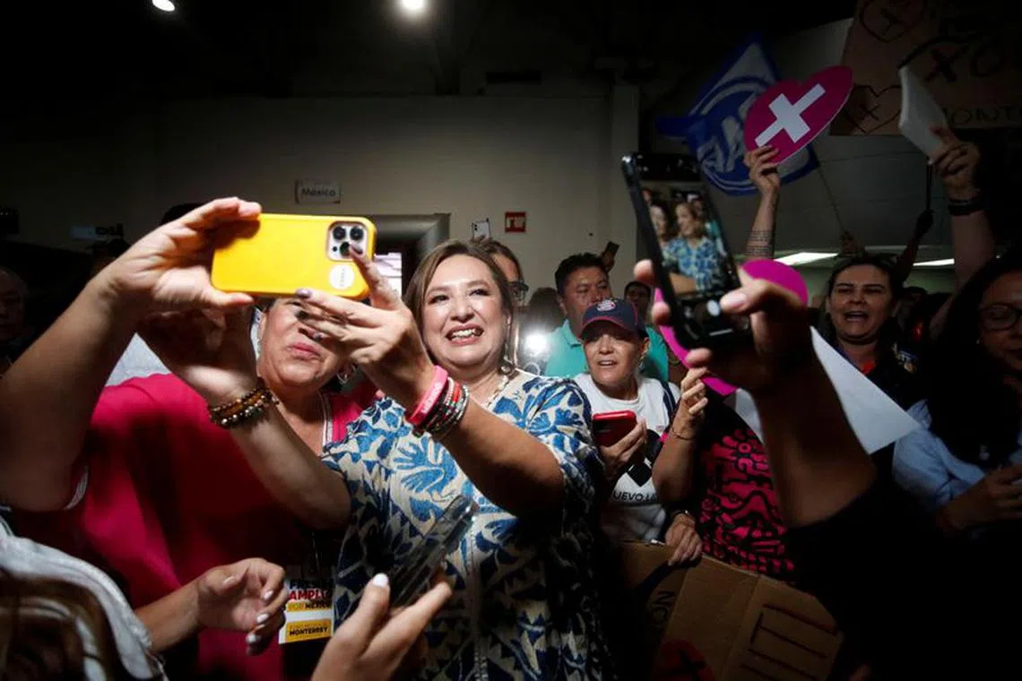 FILE PHOTO: Former Mexican Senator Xochitl Galvez takes a selfie with a woman after a private event as she pursues the Frente Amplio por Mexico opposition alliance's candidacy for the 2024 presidential election, in Monterrey, Mexico, August 19, 2023. REUTERS/Daniel Becerril