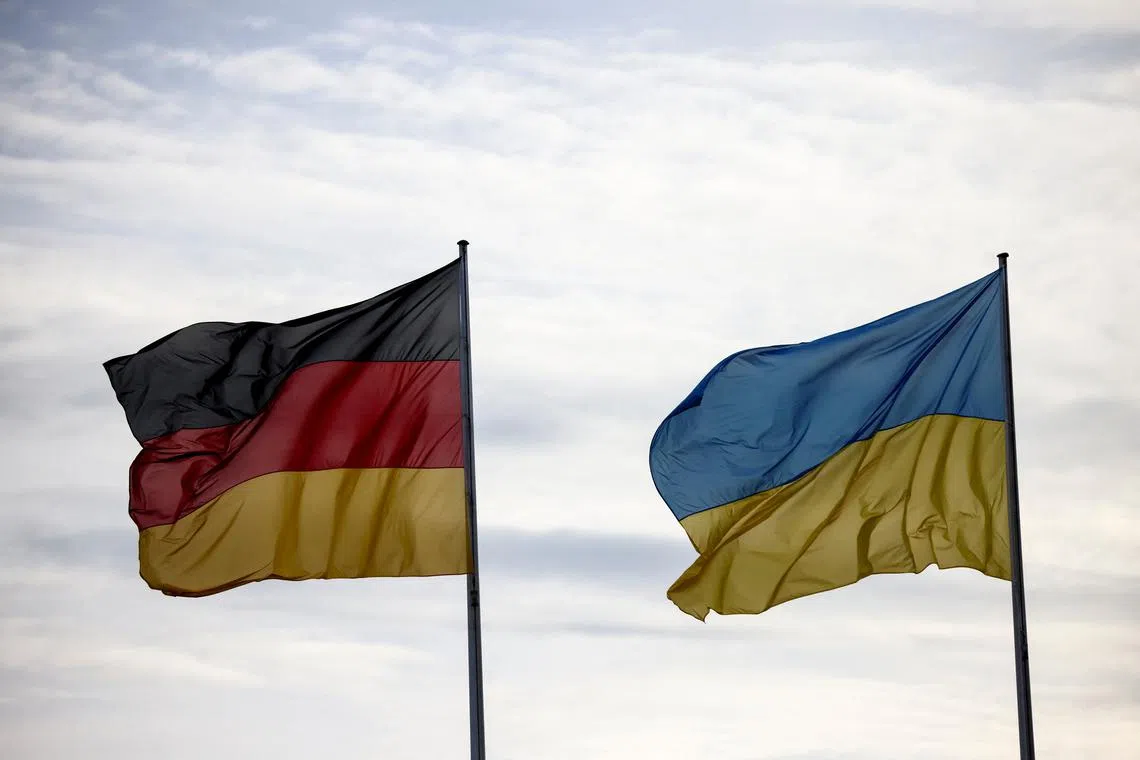 FILE PHOTO: Flags of Germany and Ukraine fly, on the day Ukraine's President Volodymyr Zelenskiy visits Berlin, Germany, February 16, 2024. REUTERS/Liesa Johannssen/File Photo