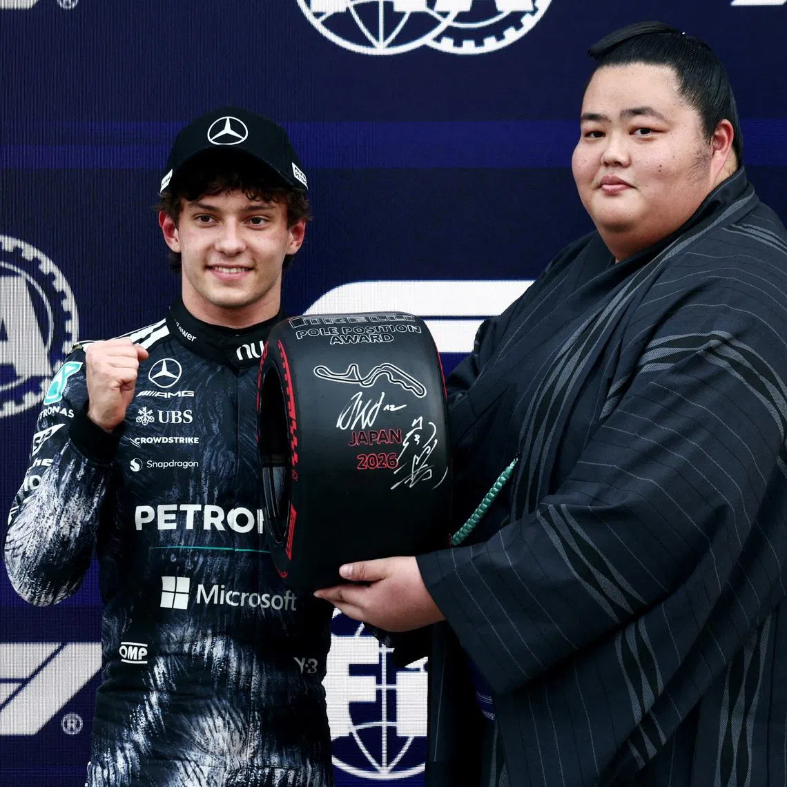 Formula One F1 - Japanese Grand Prix - Suzuka Circuit, Suzuka, Japan - March 28, 2026 Sumo Wrestler Ozeki Kotozakura presents the pole position award to Mercedes' Andrea Kimi Antonelli after qualifying in pole position REUTERS/Jakub Porzycki
