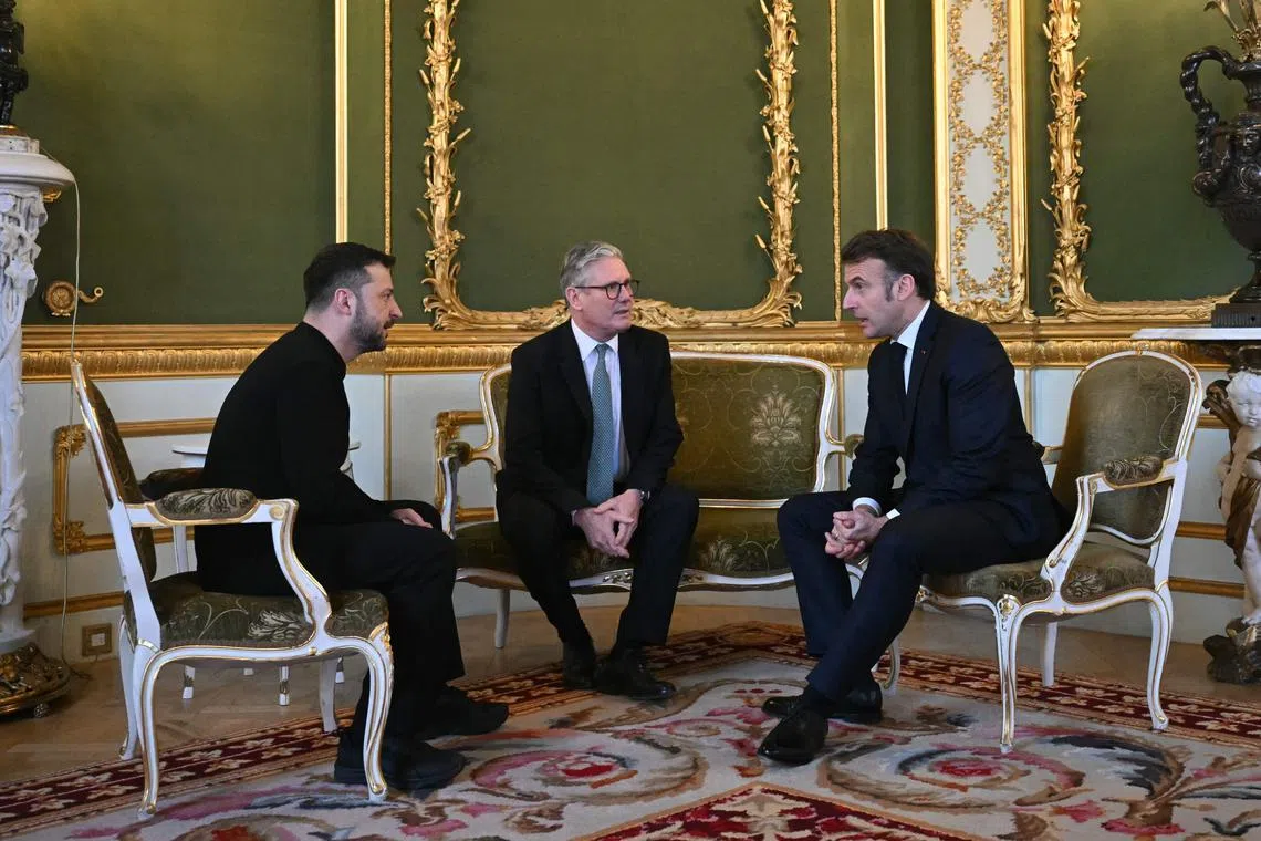 (From left) Ukraine's President Volodymyr Zelensky, Britain's Prime Minister Keir Starmer and France's President Emmanuel Macron meet after a summit at Lancaster House.