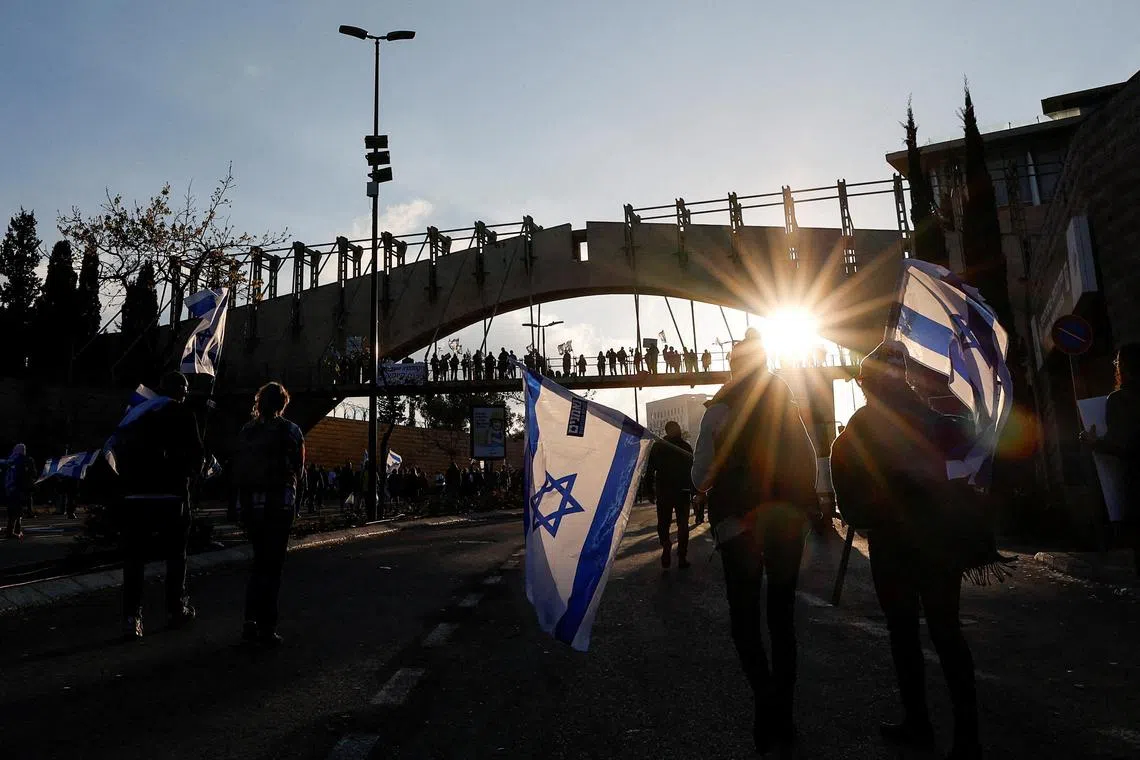 FILE PHOTO: Protesters attend a demonstration after Israeli Prime Minister Benjamin Netanyahu dismissed the defense minister and his nationalist coalition government presses on with its judicial overhaul, in Jerusalem, March 27, 2023. REUTERS/Ammar Awad/File Photo