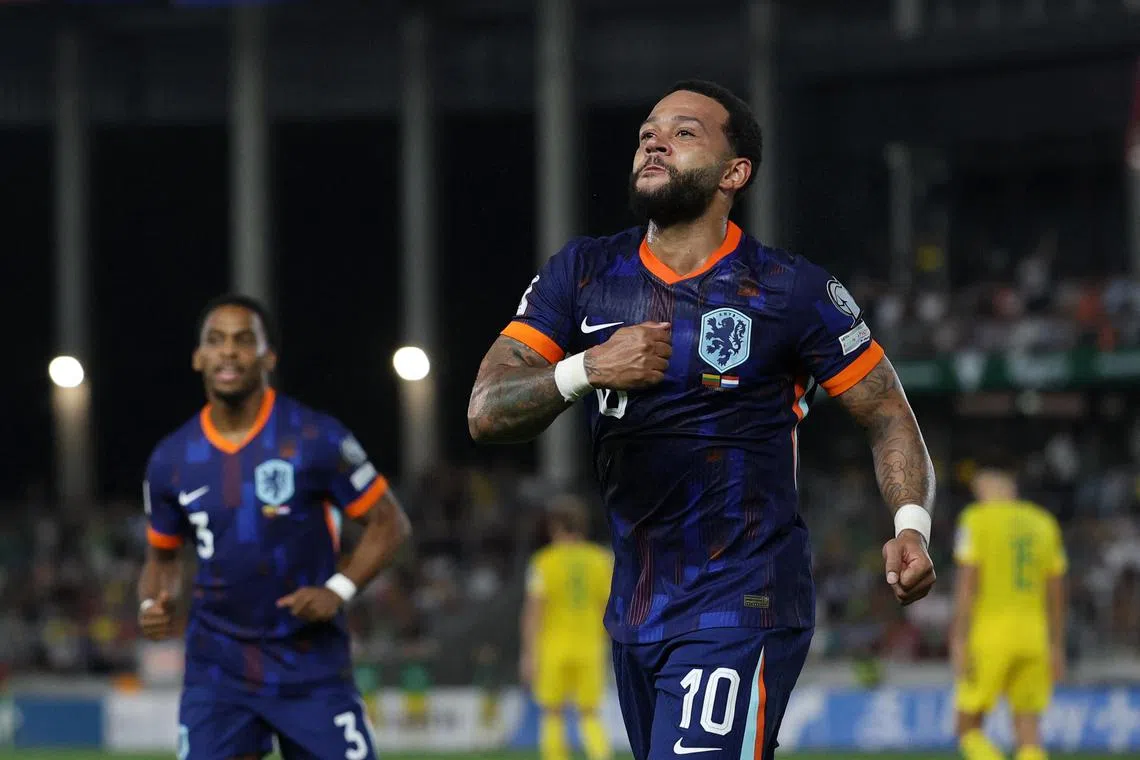 The Netherlands' Memphis Depay celebrates scoring their third, winning goal.