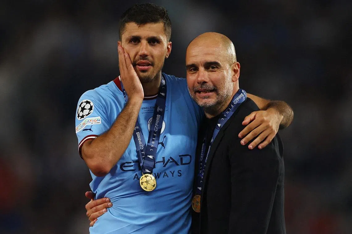 Manchester City's Rodri and manager Pep Guardiola celebrate after winning the Champions League. 