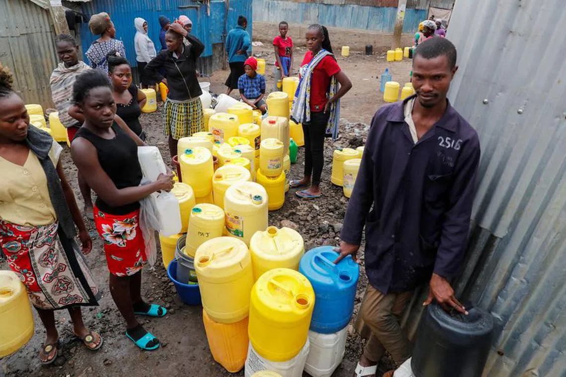 Residents gather with their jerrycans to collect water from a tap in Mukuru slums within the Industrial area district, in Nairobi, Kenya September 4, 2023. REUTERS/Thomas Mukoya