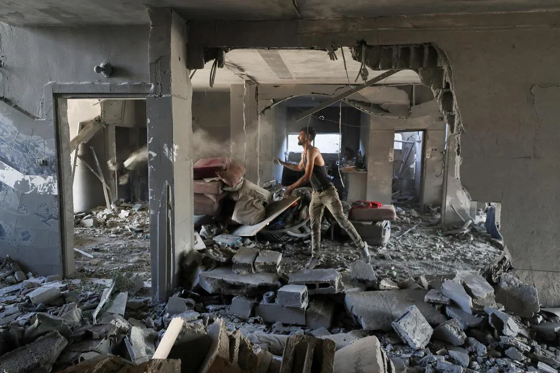 A Palestinian inspecting the site of an Israeli strike that damaged and destroyed residential buildings, in Gaza City, on July 4.