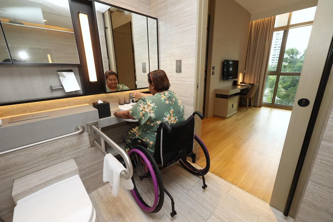 Ms D.G. Carole Ann using the bathroom sink which allows her to roll her wheelchair in. 