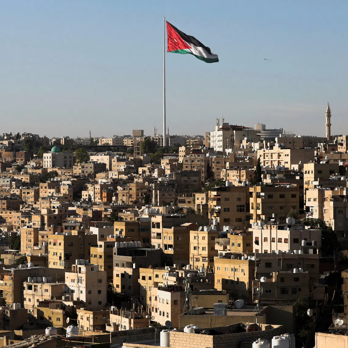 A Jordanian flag flies over the capital city, Amman, Jordan August 17, 2025. REUTERS/Mohamed Abd El Ghany