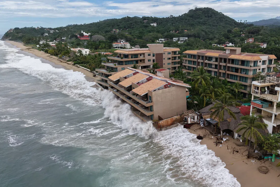 A drone view shows waves crash against beachfront buildings as Hurricane Simon remains off Mexico's Pacific coast, in San Francisco, Bahia de Banderas, Nayarit state, Mexico, October 12, 2026. REUTERS/Christian Ruano