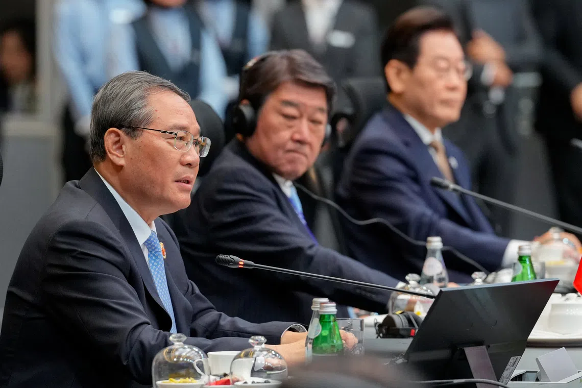 China's Premier Li Qiang, gives his opening remark as Japan's Minister of Foreign Affairs Toshimitsu Motegi, center, and South Korea President Lee Jae Myung sit next to him during the 28th ASEAN Plus Three Summit in Kuala Lumpur, Malaysia, Monday, Oct. 27, 2025.       Vincent Thian/Pool via REUTERS