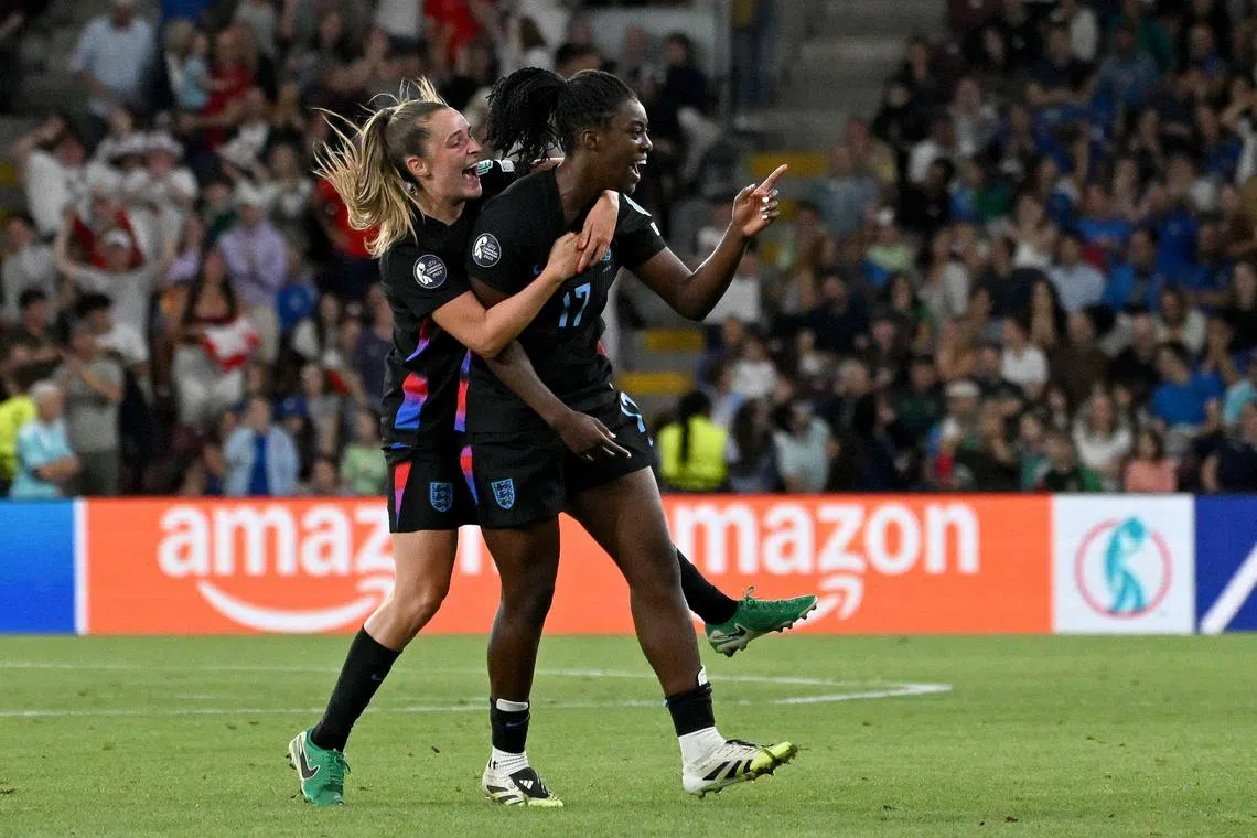 England forward Michelle Agyemang celebrates with midfielder Ella Toone (L) after scoring in stoppage time against Italy.