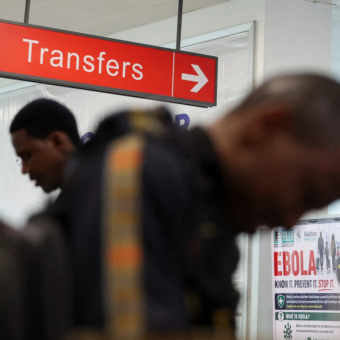 Travellers arrive for health screening at Murtala Muhammed International Airport following reports of an Ebola case in Nigeria on Oct 22.
