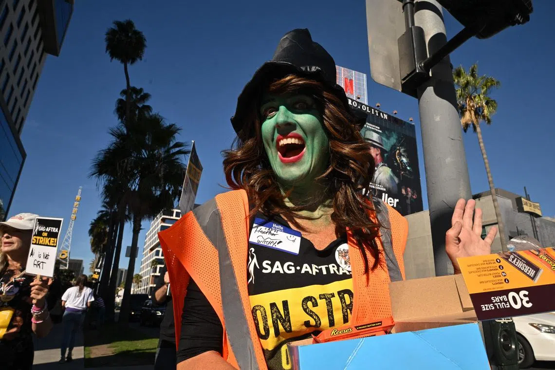 SAG-AFTRA members dress in costume for Halloween as they walk the picket line outside Netflix Studios in Hollywood. 