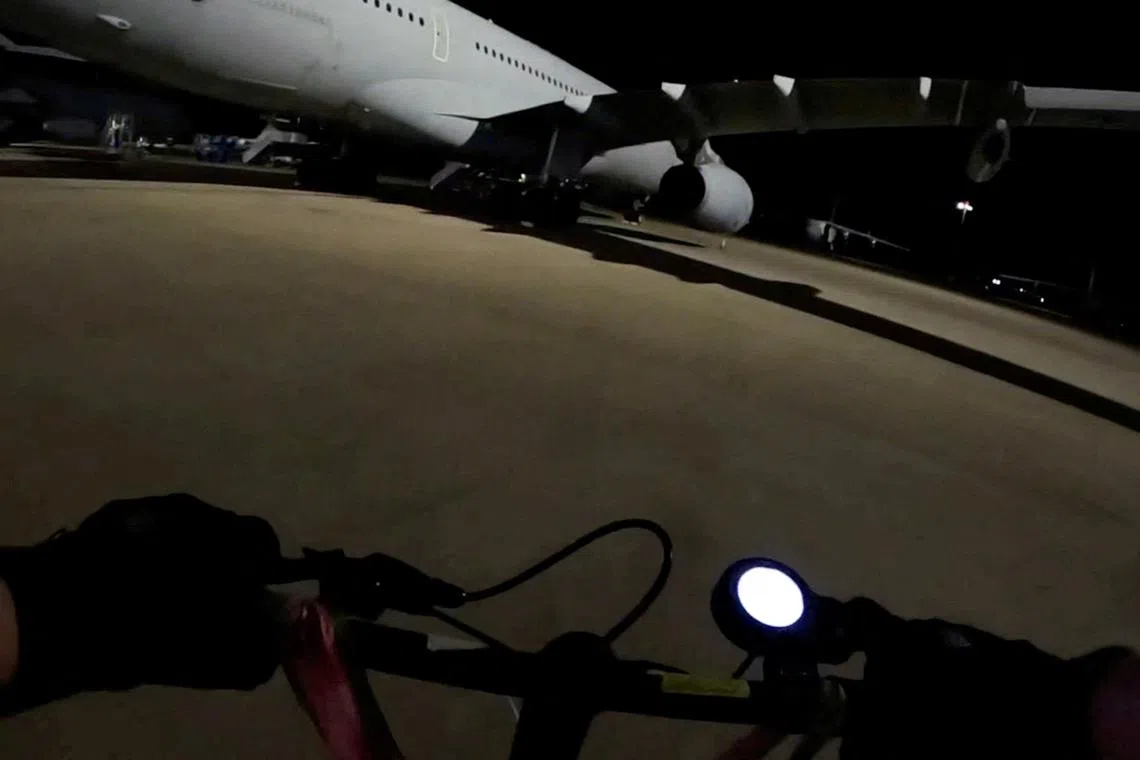 One of two activists from Palestine Action approaching a military aircraft to spray it with paint in Carterton, Britain, on June 20.